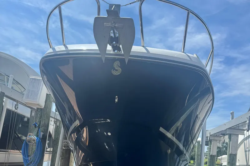 Slide: The Image of 2023 Beneteau Gran Turismo 32 yacht docked under clear blue sky. - 2