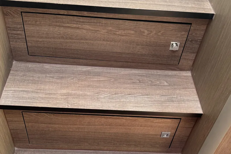 Slide: The Image of Wooden storage compartments on the 2023 Beneteau Gran Turismo 32 yacht interior. - 22