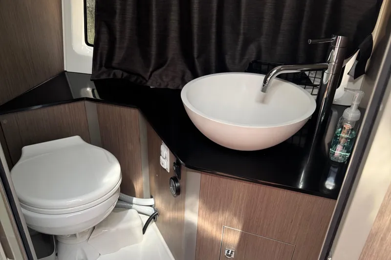 Slide: The Image of Modern bathroom in 2023 Beneteau Gran Turismo 32 yacht, featuring sleek sink and toilet. - 25