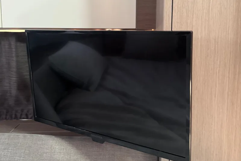 Slide: The Image of Flat-screen TV in the cabin of a 2023 Beneteau Gran Turismo 32 yacht. - 29