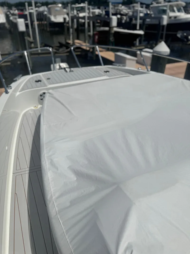 Slide: The Image of 2023 Beneteau Gran Turismo 32 yacht docked, covered deck, marina background. - 31