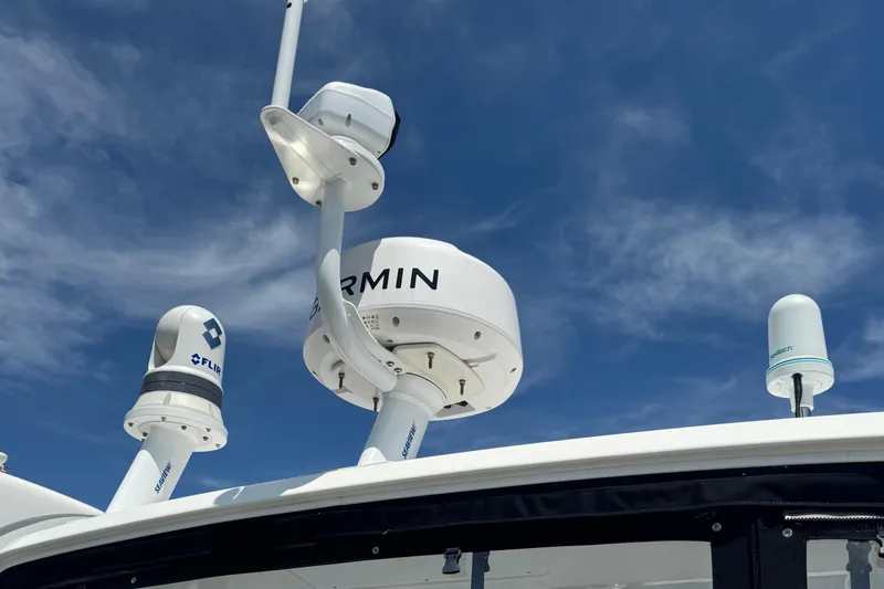 Slide: The Image of Radar and communication equipment on 2023 Beneteau Gran Turismo 32 against blue sky. - 5