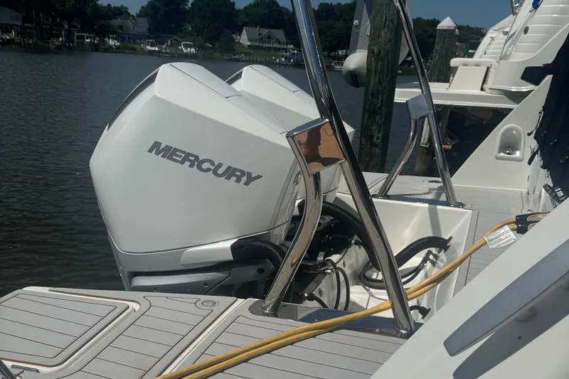 Slide: The Image of 2023 Beneteau Gran Turismo 32 with Mercury outboard engine docked by the water. - 7