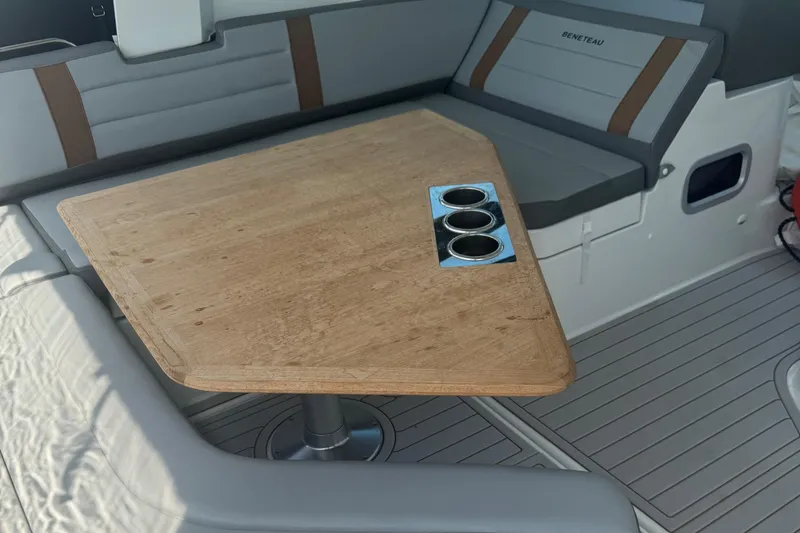 Slide: The Image of Interior of 2023 Beneteau Gran Turismo 32 with wooden table and cushioned seating. - 9