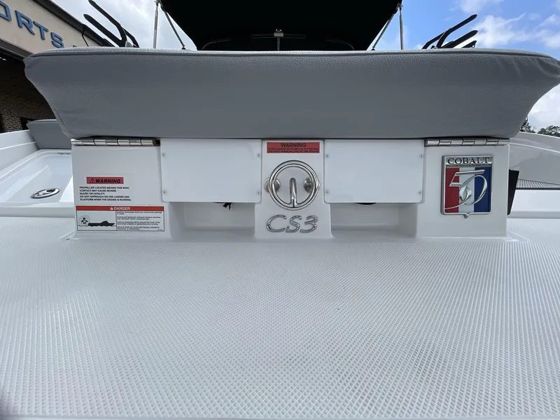 Slide: The Image of 2018 Cobalt CS23 Surf boat rear view with logo and warning labels. - 10