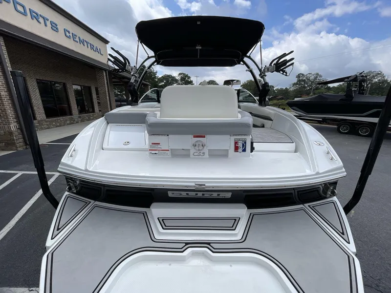 Slide: The Image of 2018 Cobalt CS23 Surf boat at dealership, rear view with seating and swim platform. - 11