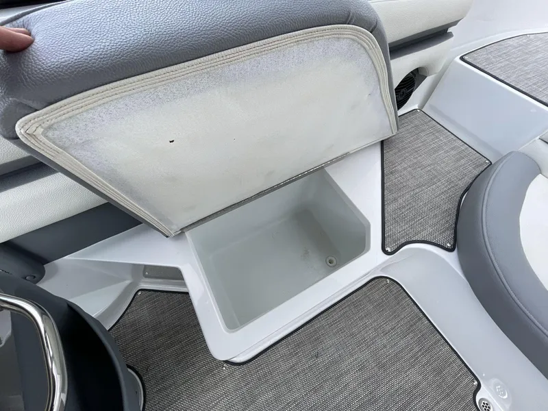 Slide: The Image of 2018 Cobalt CS23 Surf boat interior storage compartment with gray upholstery and flooring. - 15