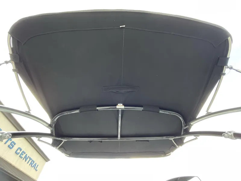 Slide: The Image of 2018 Cobalt CS23 Surf boat canopy viewed from below, featuring sleek metal framework. - 17