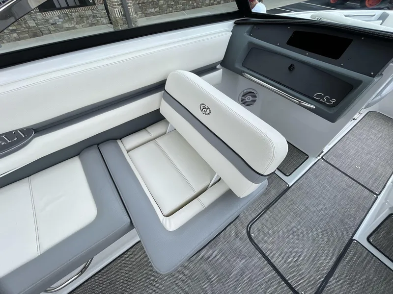 Slide: The Image of 2018 Cobalt CS23 Surf boat interior with white and gray seating and dashboard. - 22