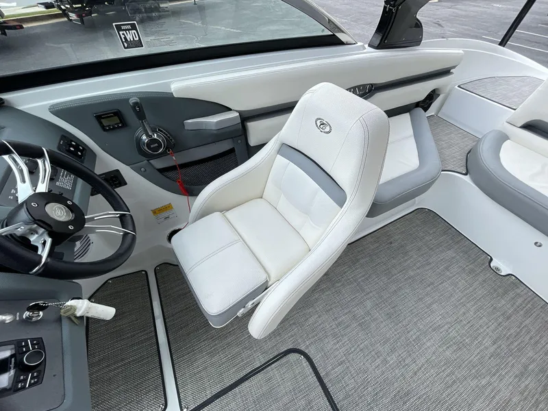 Slide: The Image of Interior of a 2018 Cobalt CS23 Surf boat with white seating and modern controls. - 26