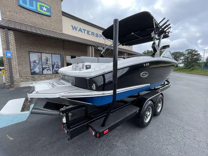 Slide: The Image of 2018 Cobalt CS23 Surf boat on trailer outside Watersports store. - 3