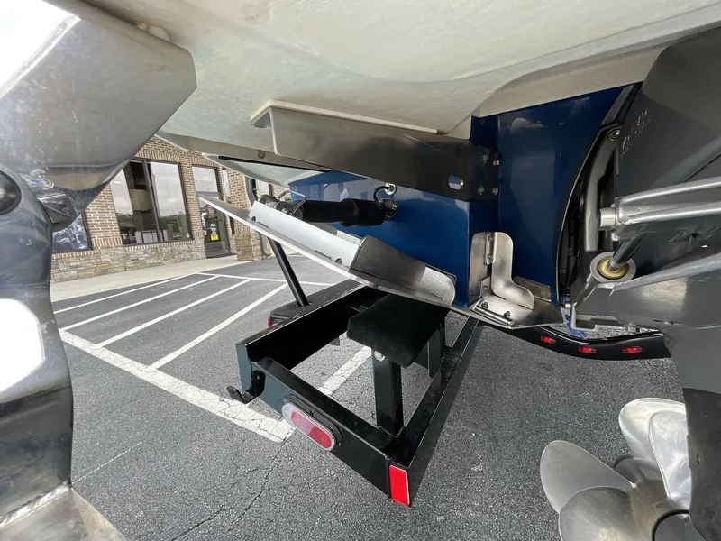 Slide: The Image of 2018 Cobalt CS23 Surf boat trailer hitch and propeller in parking lot. - 5