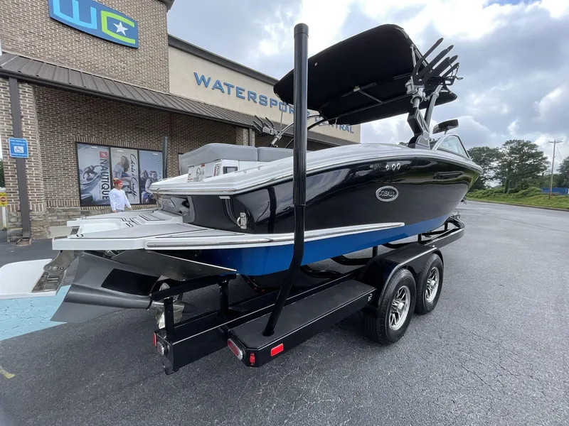 Slide: The Image of 2018 Cobalt CS23 Surf boat on trailer outside Watersports Central. - 7