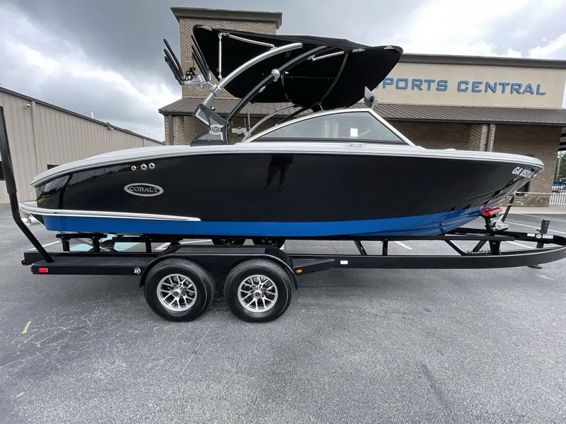 Slide: The Image of 2018 Cobalt CS23 Surf boat on trailer, parked outside Sports Central. - 8