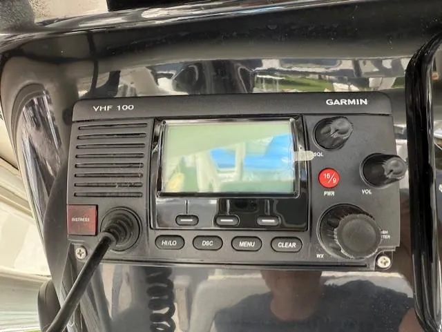 Slide: The Image of Garmin VHF 100 radio on 2018 Wellcraft 302 Fisherman boat dashboard. - 10