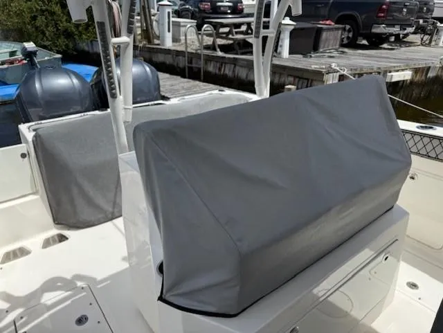 Slide: The Image of 2018 Wellcraft 302 Fisherman boat with covered seating and dual outboard motors at a dock. - 11