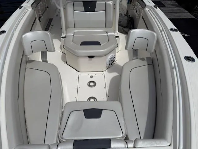 Slide: The Image of 2018 Wellcraft 302 Fisherman boat interior with cushioned seating and storage compartments. - 17