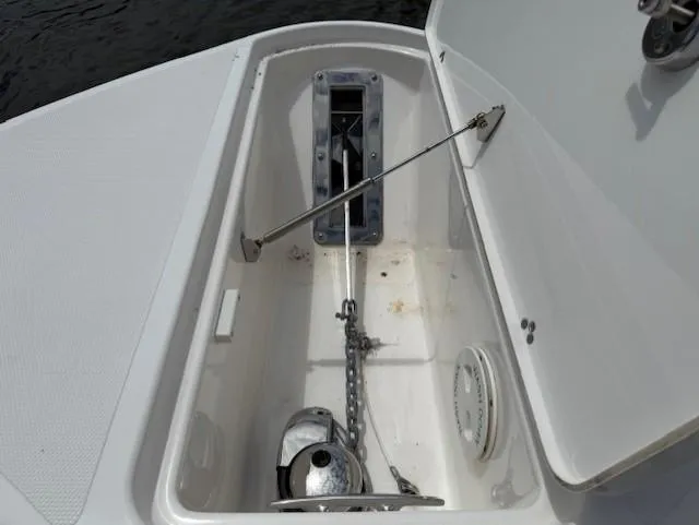 Slide: The Image of Anchor storage compartment on 2018 Wellcraft 302 Fisherman boat, featuring chain and winch. - 18
