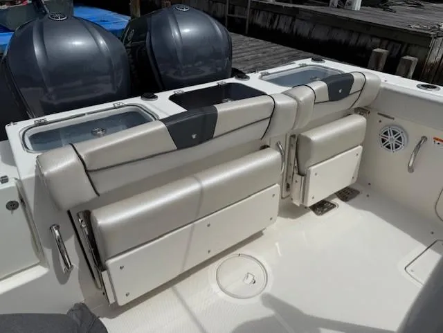 Slide: The Image of 2018 Wellcraft 302 Fisherman boat interior with dual outboard engines and cushioned seating. - 19