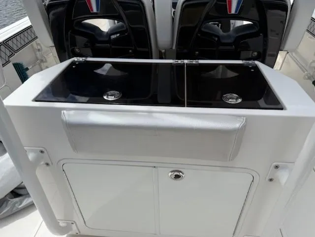 Slide: The Image of 2018 Wellcraft 302 Fisherman boat interior with dual sinks and storage cabinet. - 21