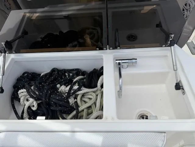Slide: The Image of 2018 Wellcraft 302 Fisherman boat sink and rope storage compartment. - 22