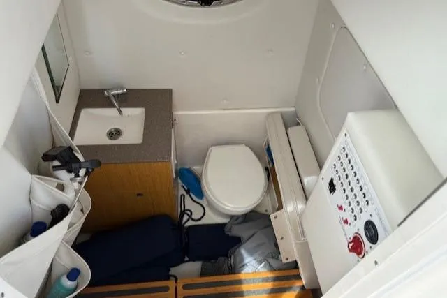 Slide: The Image of 2018 Wellcraft 302 Fisherman boat interior with sink, toilet, and control panel. - 23