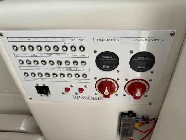 Slide: The Image of Control panel of a 2018 Wellcraft 302 Fisherman boat, featuring battery switches and circuit breakers. - 24