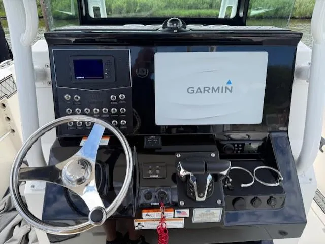 Slide: The Image of 2018 Wellcraft 302 Fisherman helm with Garmin navigation system and steering wheel. - 6