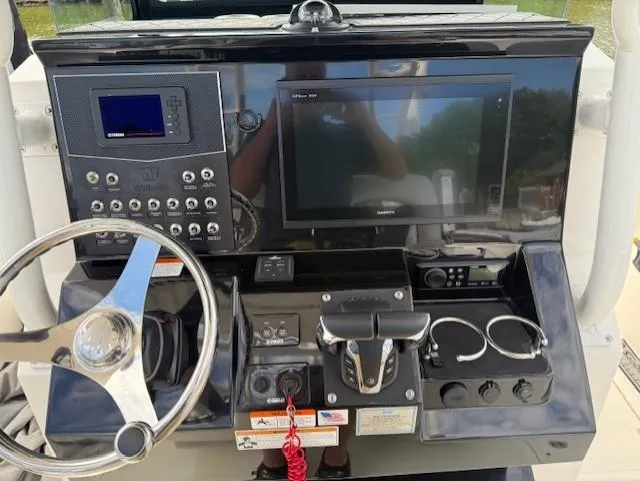 Slide: The Image of Control panel of a 2018 Wellcraft 302 Fisherman boat with steering wheel and electronic displays. - 7