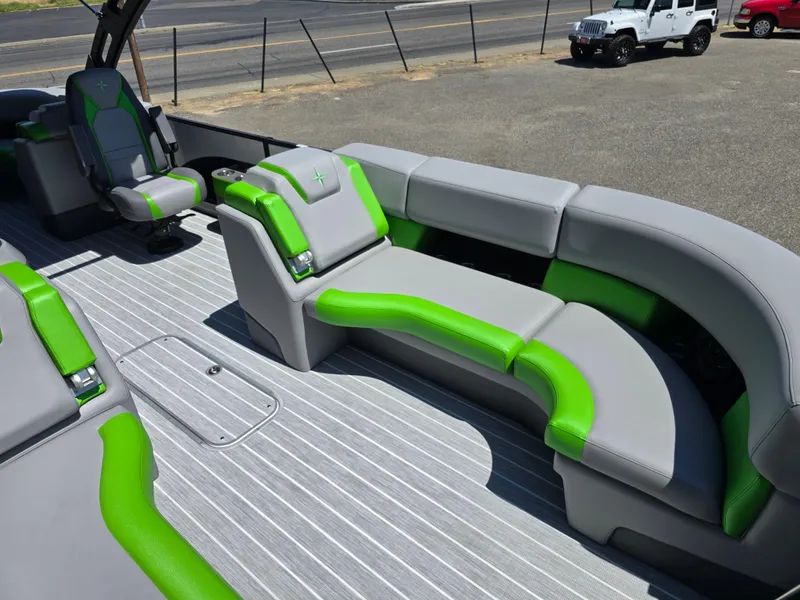 Slide: The Image of 2026 Berkshire STS 25 RFX 3.0+ boat interior with gray and green seating. - 12