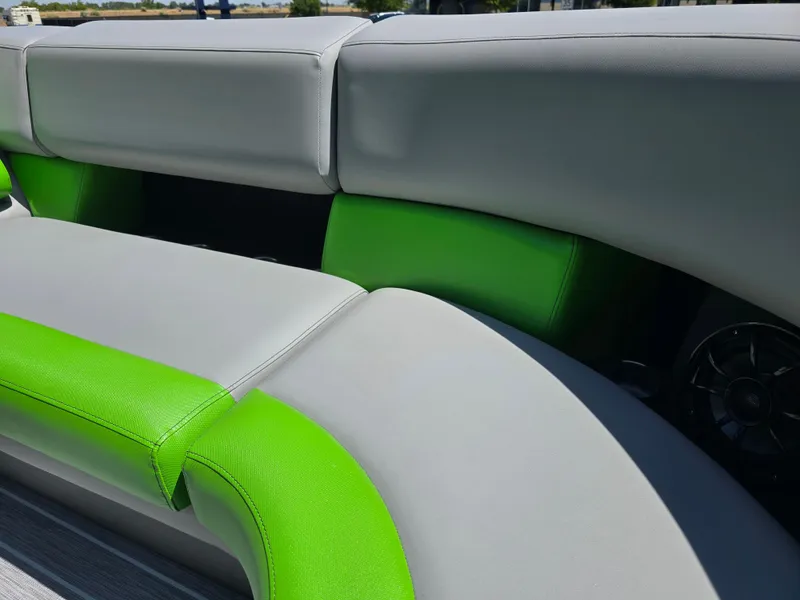 Slide: The Image of 2026 Berkshire STS 25 RFX 3.0+ boat interior with gray and green seating. - 13