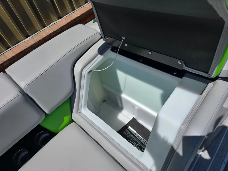 Slide: The Image of Open storage compartment in 2026 Berkshire STS 25 RFX 3.0+ boat with cushioned seating. - 14