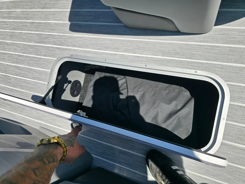 Slide: The Image of Open storage compartment on 2026 Berkshire STS 25 RFX 3.0+ boat deck. - 16