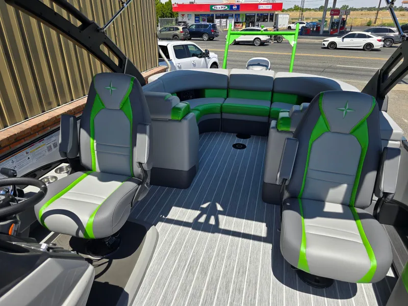 Slide: The Image of 2026 Berkshire STS 25 RFX 3.0+ boat interior with green and gray seating. - 17