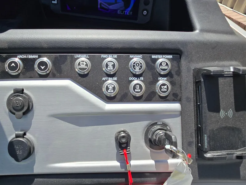 Slide: The Image of Control panel of 2026 Berkshire STS 25 RFX 3.0+ boat with various switches and ports. - 21