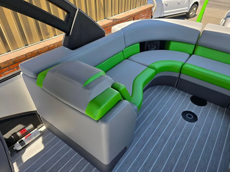 Slide: The Image of 2026 Berkshire STS 25 RFX 3.0+ boat interior with green and gray seating. - 25