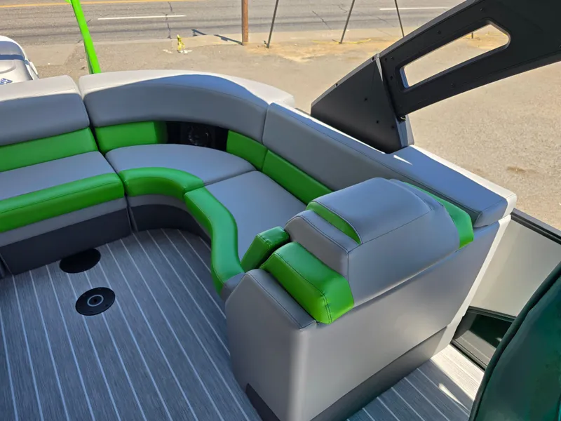 Slide: The Image of 2026 Berkshire STS 25 RFX 3.0+ boat interior with green and gray seating. - 26