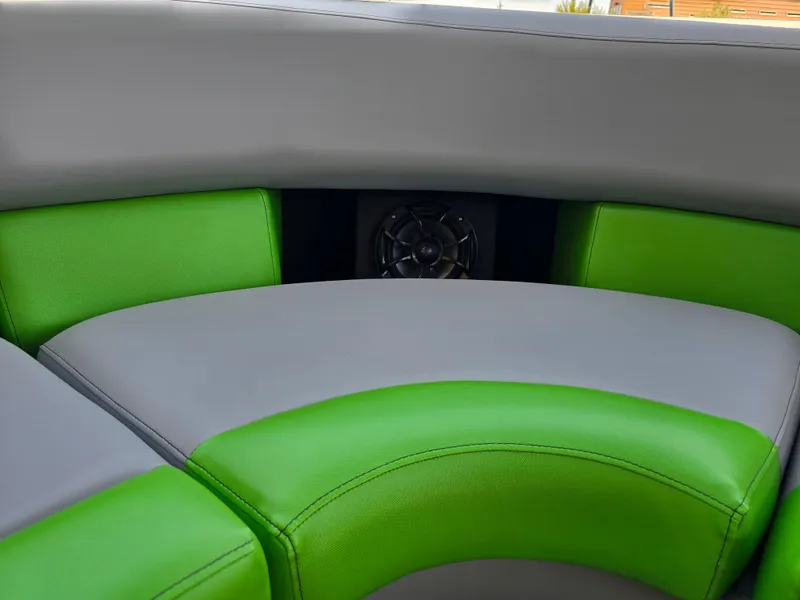 Slide: The Image of 2026 Berkshire STS 25 RFX 3.0+ boat interior with green and gray seating. - 28