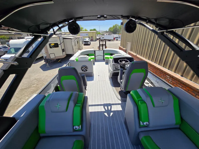 Slide: The Image of 2026 Berkshire STS 25 RFX 3.0+ pontoon boat interior with green accents and modern design. - 29