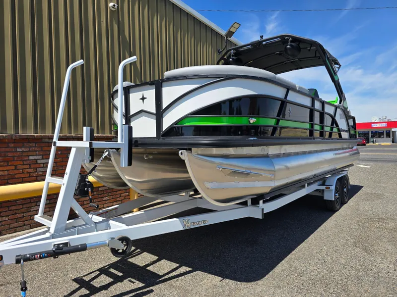 Slide: The Image of 2026 Berkshire STS 25 RFX 3.0+ pontoon boat on trailer, parked outdoors. - 3