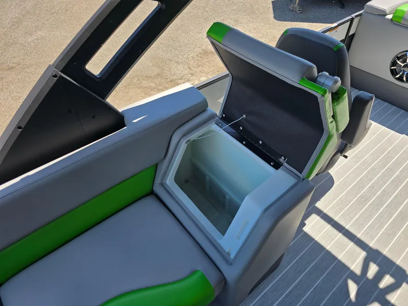 Slide: The Image of 2026 Berkshire STS 25 RFX 3.0+ boat interior with open storage compartment, gray and green seating. - 33