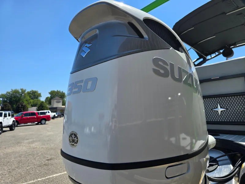 Slide: The Image of Suzuki 350 outboard motor on 2026 Berkshire STS 25 RFX 3.0+ boat, parked outdoors. - 8