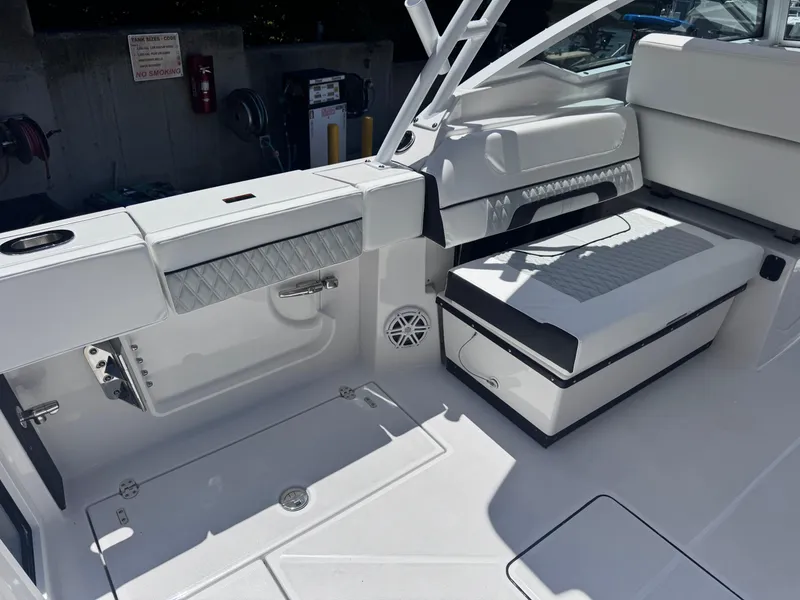 Slide: The Image of 2026 Blackfin 272 DC boat interior with white seating and storage compartments. - 14