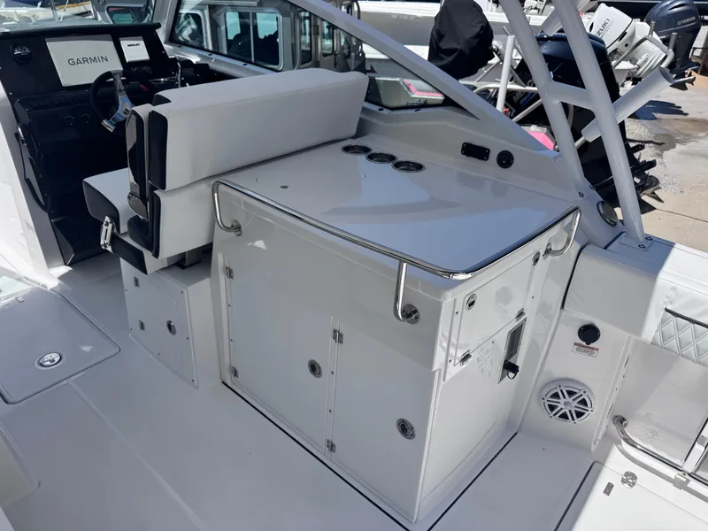 Slide: The Image of 2026 Blackfin 272 DC boat interior with helm, seating, and storage compartments. - 15