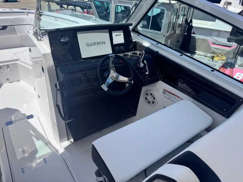 Slide: The Image of 2026 Blackfin 272 DC boat cockpit with Garmin navigation system and modern steering wheel. - 20