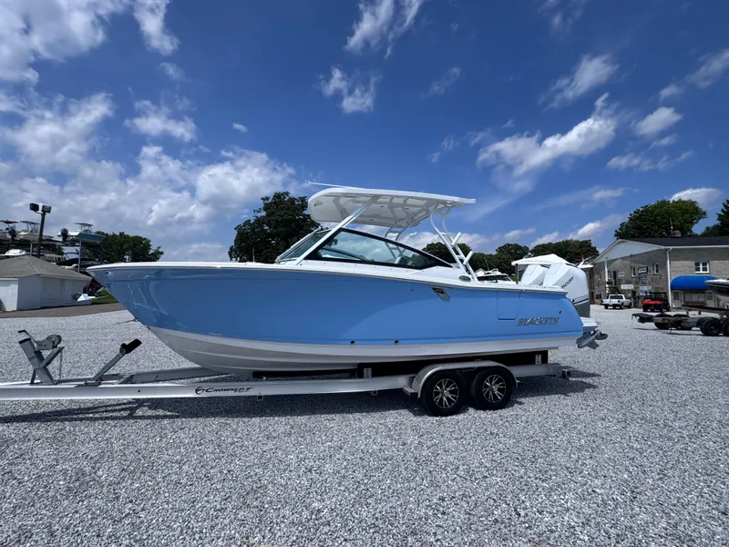 Slide: The Image of 2026 Blackfin 272 DC boat on trailer under blue sky. - 3