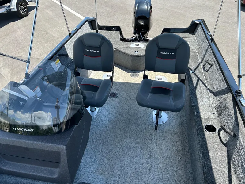 Slide: The Image of 2022 Tracker Pro Guide V-16 SC boat interior with two seats and steering console. - 10