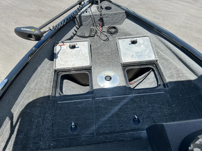 Slide: The Image of 2022 Tracker Pro Guide V-16 SC boat deck with storage compartments and trolling motor. - 12