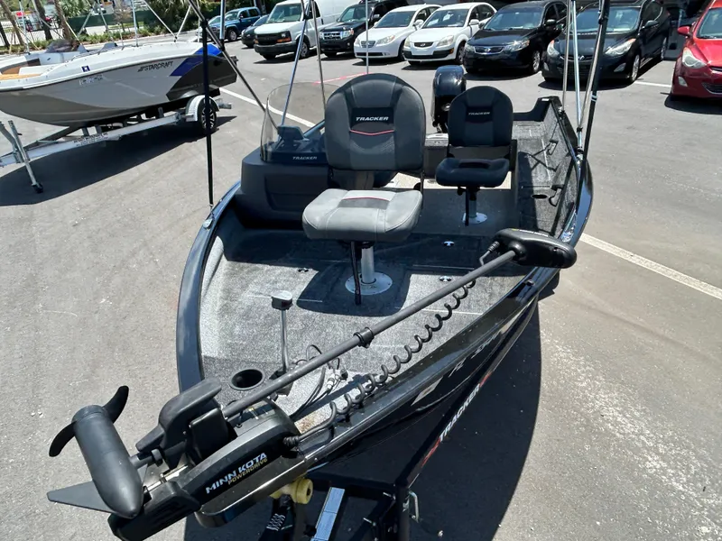 Slide: The Image of 2022 Tracker Pro Guide V-16 SC fishing boat in parking lot, featuring Minn Kota trolling motor. - 6