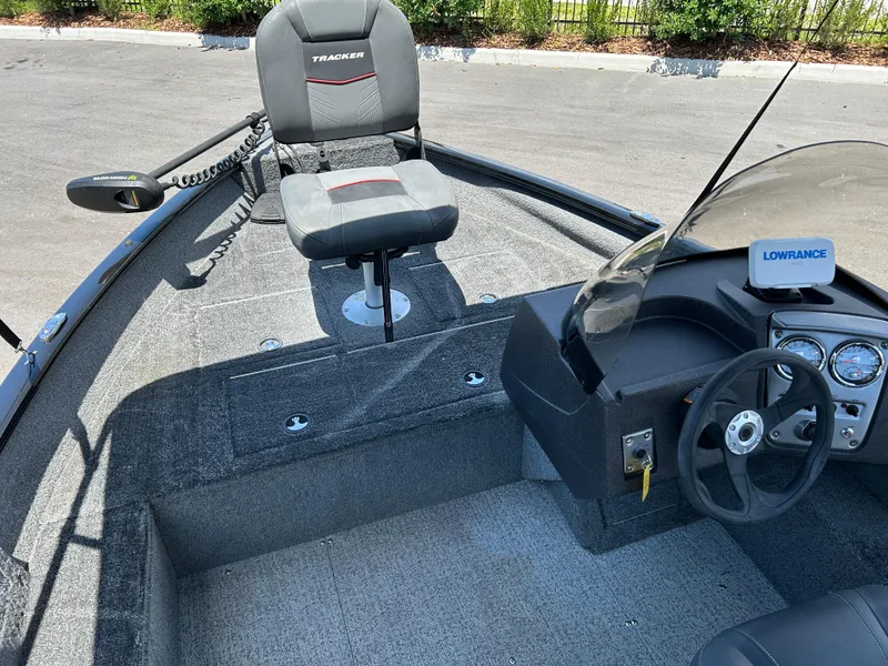 Slide: The Image of 2022 Tracker Pro Guide V-16 SC boat interior with steering wheel and seat. - 8